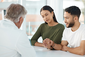 couple speaking with fertility doctor ivf